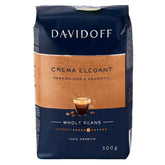The Davidoff - Crema Elegant Coffee Beans, 500g, package features a coffee cup image and highlights its "harmonious & aromatic" nature, crafted from 100% Arabica. It's perfect for anyone desiring refined intensity from Davidoff.